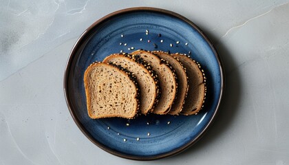 Sliced whole wheat bread on blue plate with sesame seeds for breakfast with copy space
