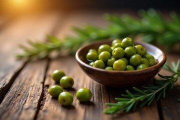 A rustic wooden surface displays a small bowl brimming with vibrant green olives, accompanied by fresh sprigs of rosemary adding a touch of aromatic elegance.