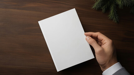 Obraz premium Blank magazine resting near pinewood surface, delicate evergreen branch complementing minimalist layout