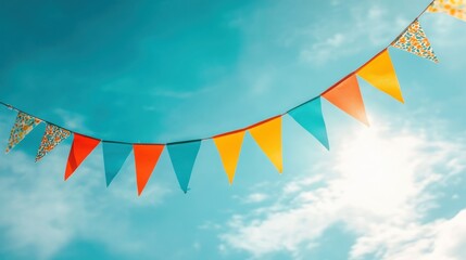Colorful bunting flags strung against a sunny blue sky (1)