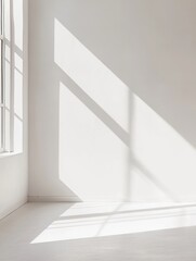Fototapeta premium Minimalist interior design showcasing natural light patterns casting sharp shadows across white walls creating airy atmosphere