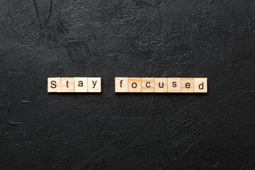 stay focused word written on wood block. stay focused text on table, concept