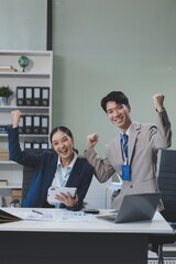Group of Asia young creative people in smart casual wear discussing business celebrate giving five after dealing feeling happy and signing contract or agreement in office. Coworker teamwork concept.