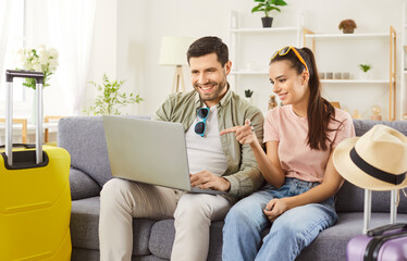 Air ticket, hotel booking service online, newlywed couple choosing tourists suitcases packed, wheel...