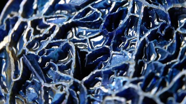 Closeup abstract motion of blue metallic surface reflecting light