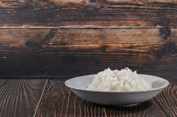 Freshly Cooked White Rice on a Decorative Plate with Wooden Background