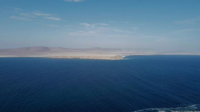 Sweeping aerial of the Paracas coastline in Peru, where desert meets the ocean