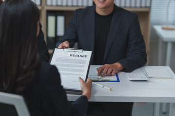 Employer giving resume to applicant during job interview