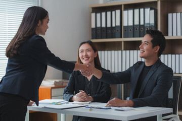 Businesspeople shaking hands during meeting in office