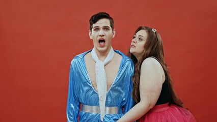 A Joyful Couple in Colorful Costumes Poses Happily Against a Striking Background