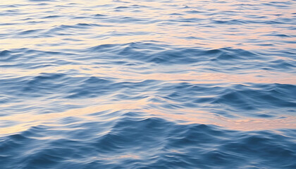 Naklejka premium Serene Rippling Waves Under Soft Sunrise Light on Calm Water Surface
