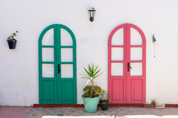 green and red doors in white mediterranean house