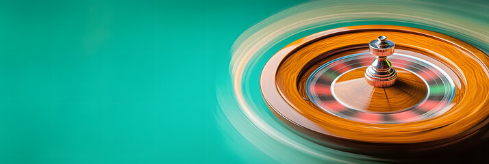 motion blur of a roulette wheel spinning at a casino wide banner - green background