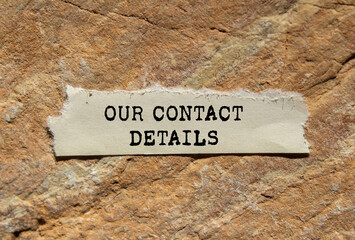 Our contact details message written on ripped torn  paper on stone background. Conceptual our contact details symbol. Copy space.