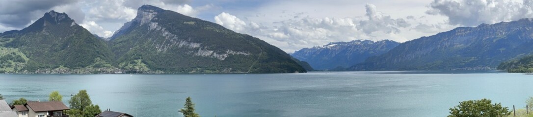 Fototapeta premium Panoramic view of lake Thunersee in the Swiss Alps mountains, Faulensee, Spiez, Bern, Switzerland, May 2024