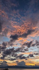 Beautiful sky with colors like pink, dark grey and a boat in the far