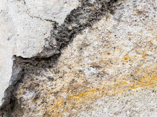 Weathered stone wall texture with cracked cement details