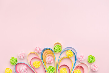 Paper strip curls with rosebuds on pink background