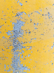 Closeup texture of yellow painted weathered concrete wall