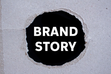 Brand story message written on ripped torn paper on black background. Conceptual brand story...
