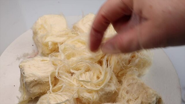 Turkish traditional dessert pismaniye, Iranian pashmak. delicate fibrous texture and melt-in-the-mouth sweetness. concept of authentic sweets, cultural confectionery, and gourmet treat