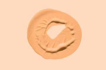Make up product smear foundation or concealer drops smudge texture beige isolated background
