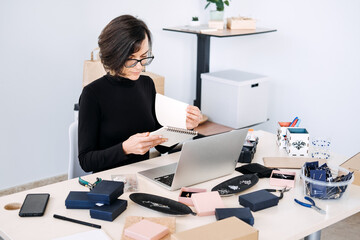 Jewelry business owner planning and organizing online sales strategy. Handmade brand management, product development, small business marketing, creative entrepreneurship