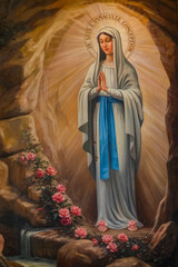 L’Escarène, FRANCE - 03-05-2025: Painting (19th century) of Apparition of the Virgin Mary, Our Lady of Lourdes or Notre Dame de Lourdes to Bernadette Soubirous.
