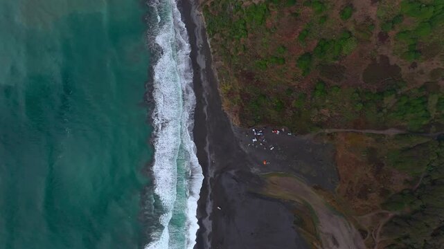 USAL Beach camping Sinkyone Wilderness Lost Coast Trail California aerial drone Birdseye view rugged untouched coastline black sand Pacific Ocean mist sunset cloudy untouched waves crashing static