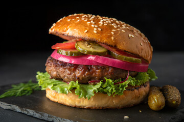 Juicy Hamburger on Black: The Perfect Presentation of Comfort Food