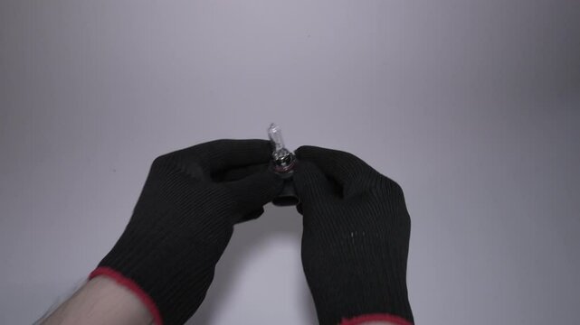 A pair of hands gently holding a keyring that features a key tag