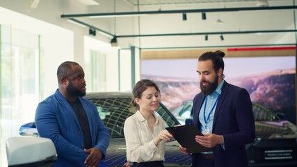Car dealership salesman asking customers questions to determine make, type and quality of vehicle...