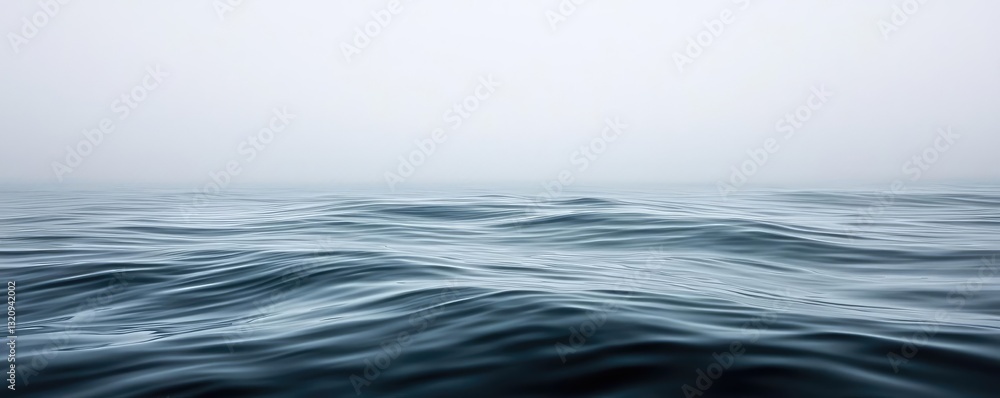 Poster Waterscape abstract background idea. Serene ocean waves gently ripple under a misty sky, creating a tranquil atmosphere.