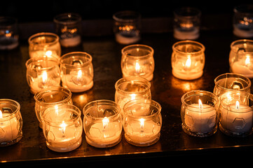 Flame candles isolated on black background. Close up burning memorial candles on the dark background