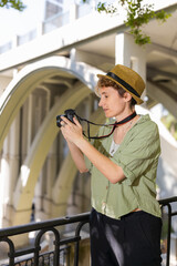 Woman photographer taking photos of a bridge in the city