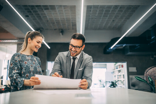 Happy business couple having conversation in office.