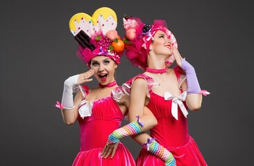 Colorful performers celebrate in playful outfits during a creative event
