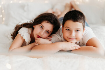 Studio portrait of preteen siblings or cousins in a festive Christmas setting