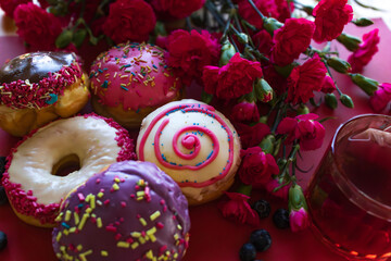 Glazed and decorated donuts in a box, showcasing a variety of flavors and toppings, with vibrant...