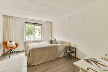 A serene and stylish modern bedroom featuring a cozy bed, simple decor, and natural light streaming through the window, creating a calm atmosphere.