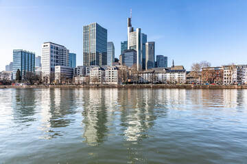 Obraz premium view to modern skyline of Frankfurt wit skyscraper and. with river Main in foreground