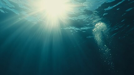 Fototapeta premium Ethereal underwater scene with bubbles rising from the ocean floor, illuminated by sunlight. Dreamy deep blue water creating a sense of tranquility, depth, and mystery beneath the surface.
