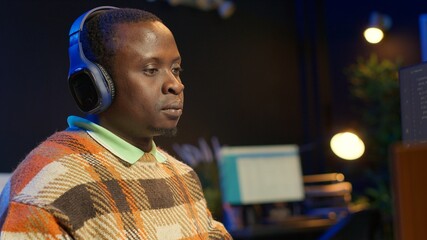 African american IT professional managing AI system for machine learning, coding software on terminal window. Futuristic program focuses on security, networking for database. Close up. Camera B.