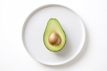 Fresh avocado sliced in half revealing smooth green flesh and br