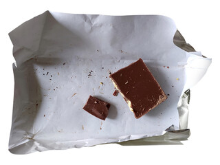 A partially eaten chocolate bar rests on crumpled white paper, hinting at indulgence and satisfaction.