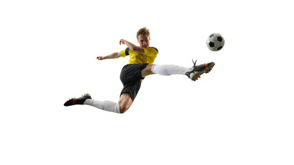 Determined man, soccer player during intensive match, kicking ball mid-air, playing isolated on...