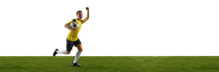 Emotional young ma, soccer player in yellow jersey and black shorts running on field with trophy,...