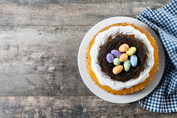 Homemade Easter egg cake on wooden table. Top view. Copy space