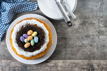 Homemade Easter egg cake on wooden table. Top view. Copy space