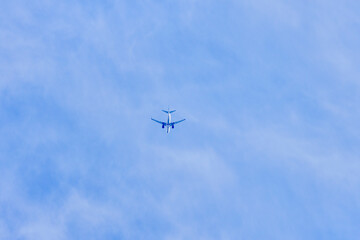 a passenger plane in the sky seen from behind